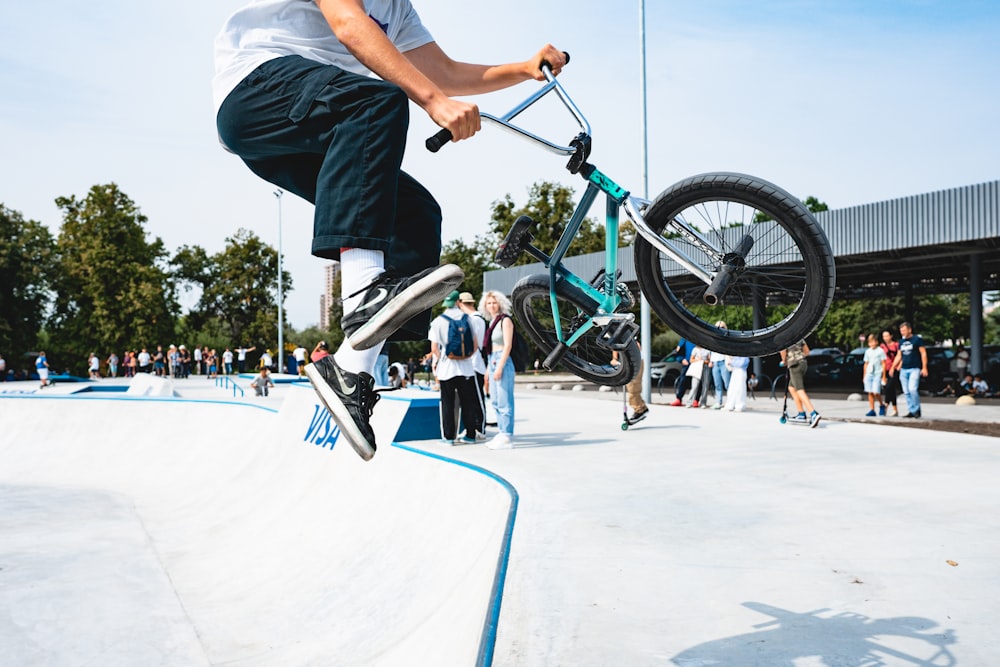 man in gray t-shirt riding green bmx bike