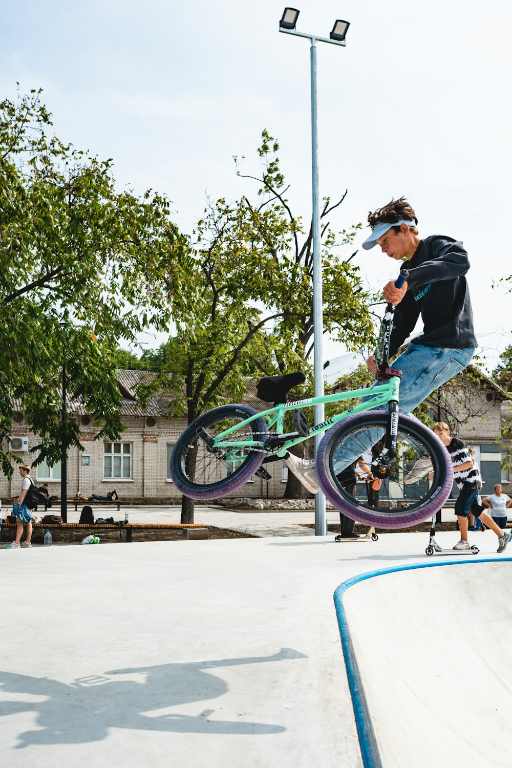 man in black jacket riding bicycle during daytime