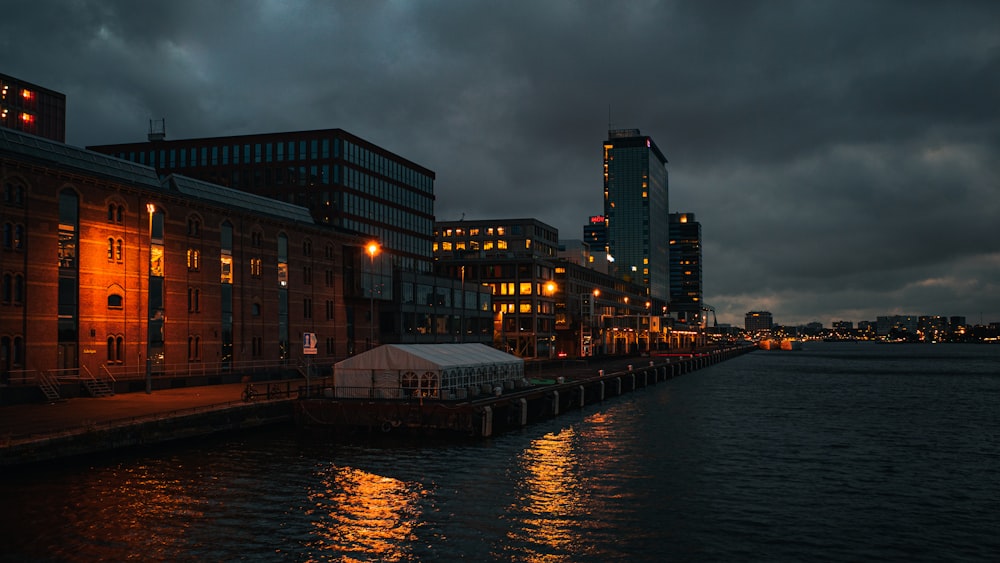 brown concrete building near body of water during night time