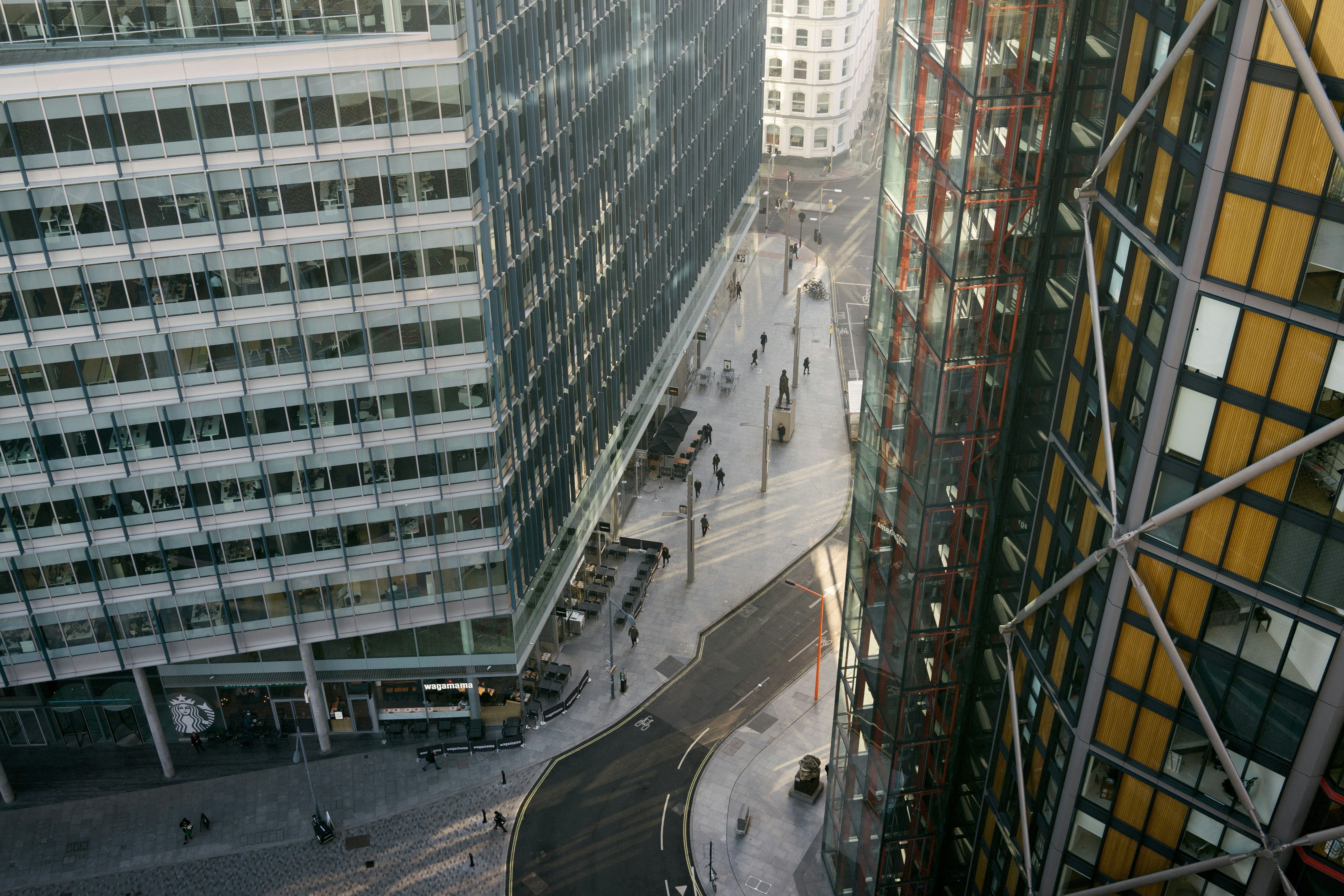 cars on road near high rise buildings during daytime