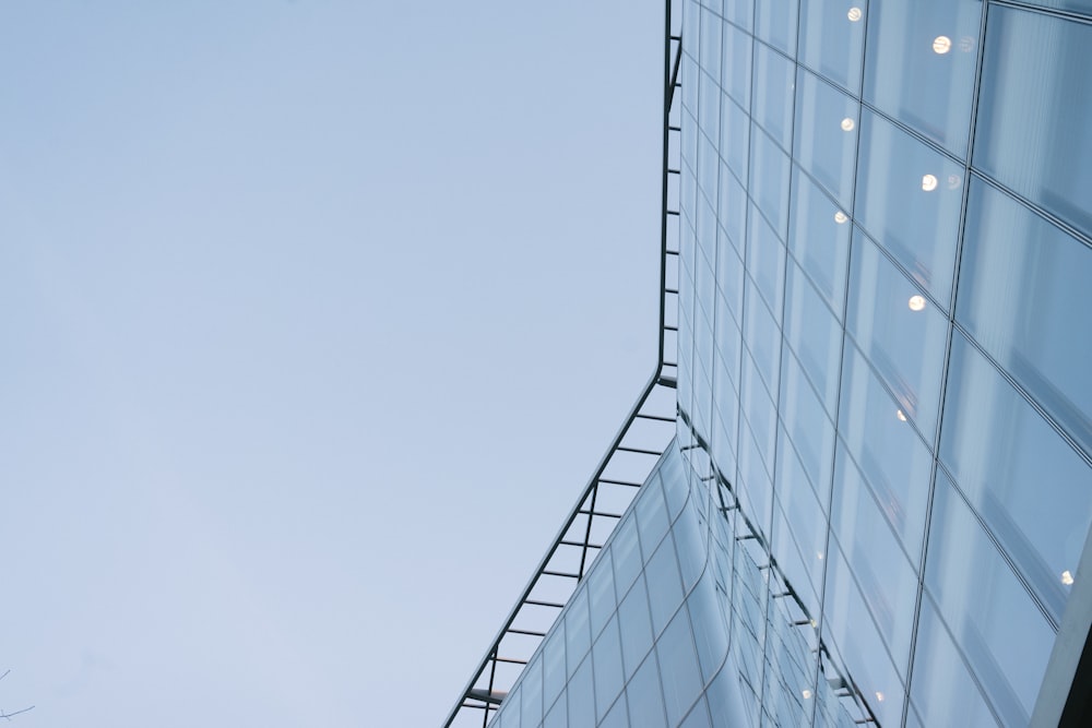 white and blue glass walled high rise building