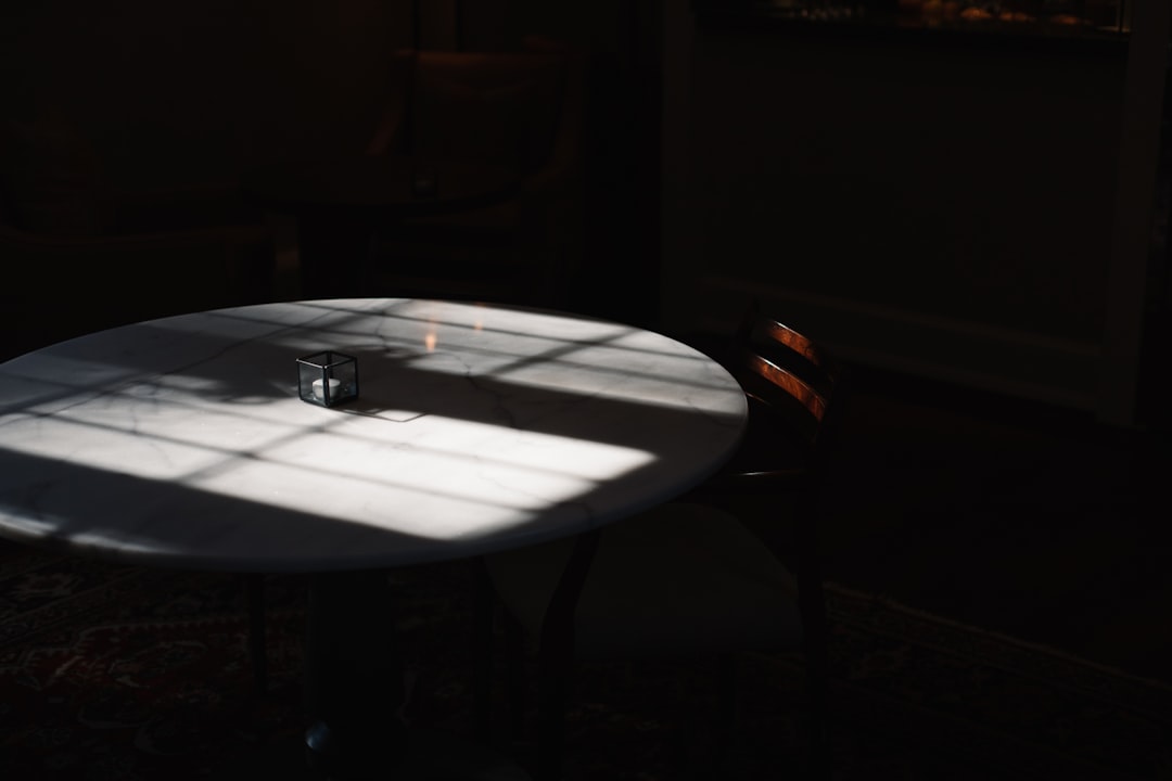 black framed eyeglasses on white round table