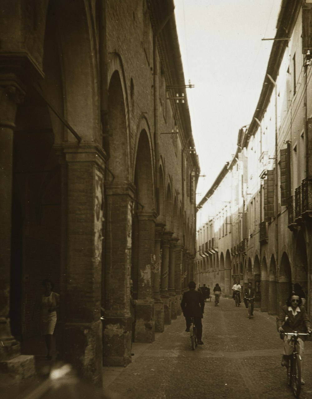 people walking on street in grayscale photography