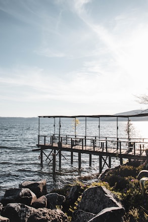 brown wooden dock on sea during daytime