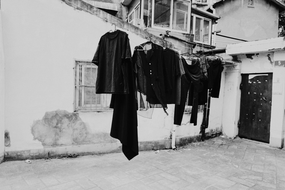 clothes hanged on white metal rack