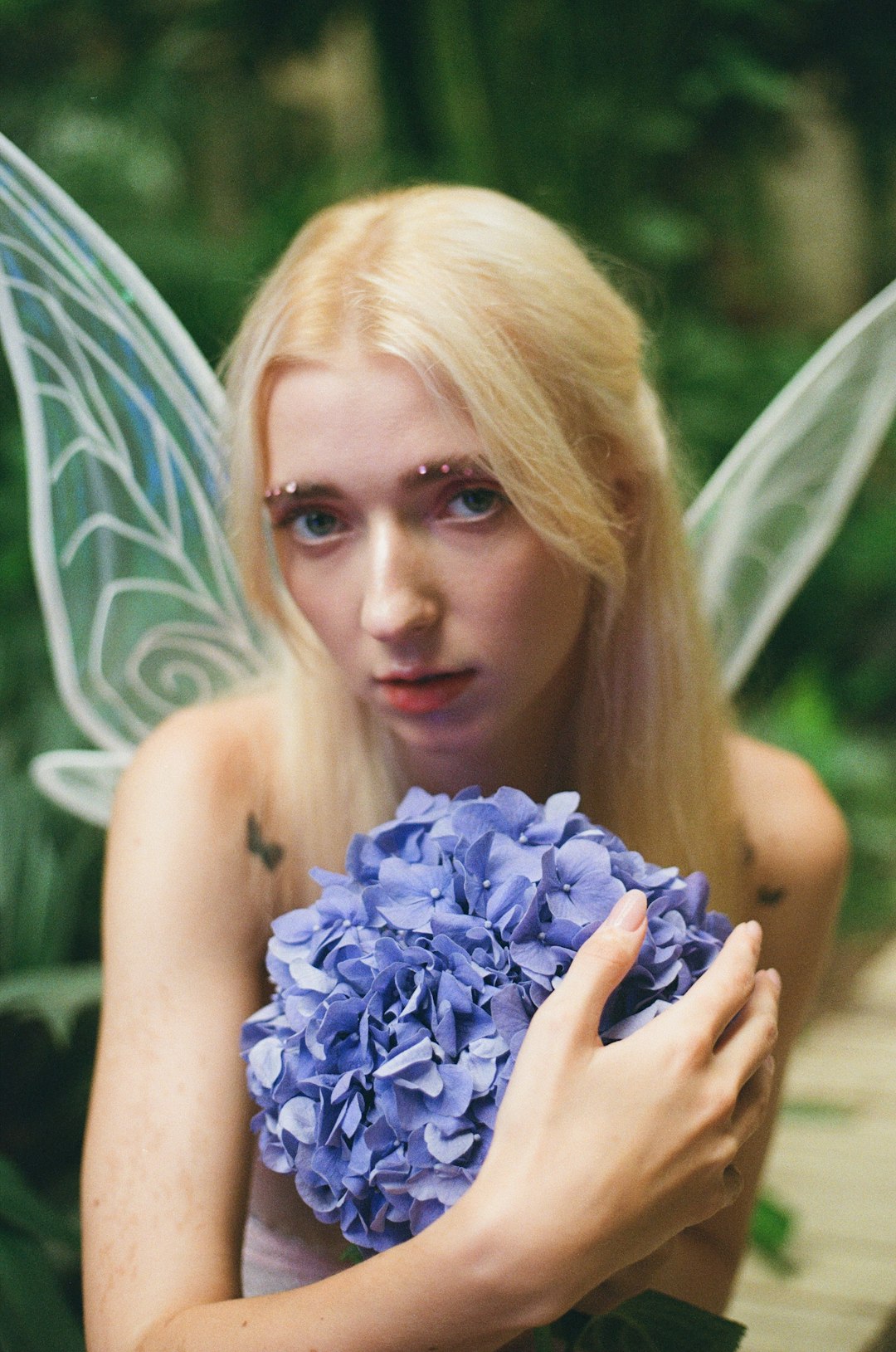 woman holding blue flower bouquet