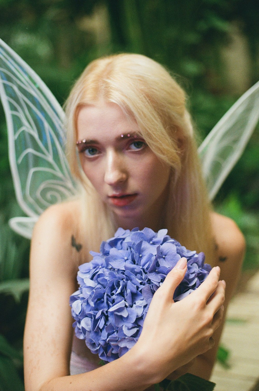 woman holding blue flower bouquet