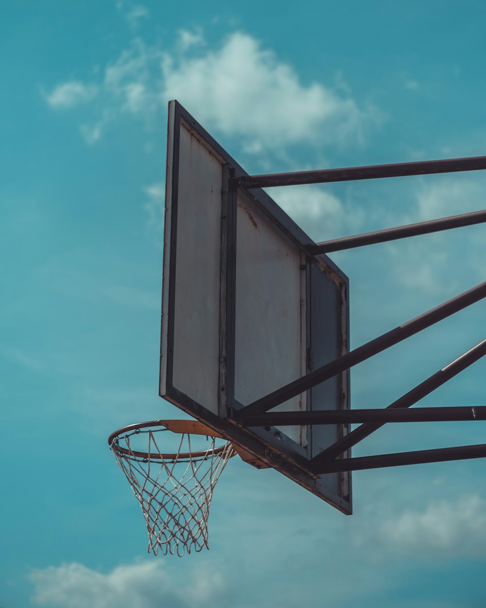 black and white basketball hoop under blue sky