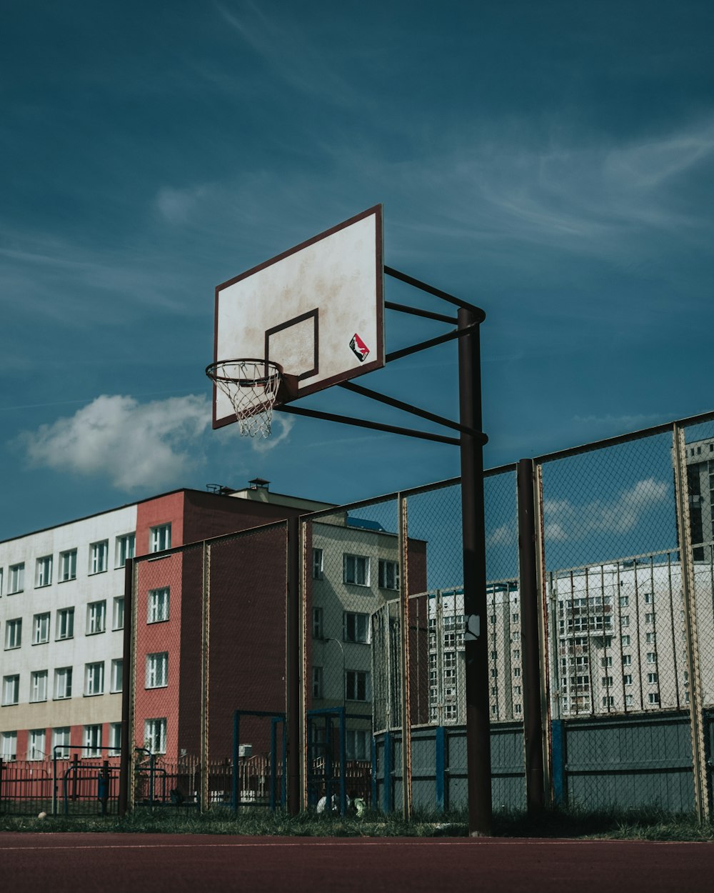 basketball hoop near brown building during daytime