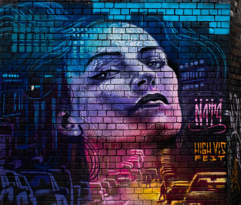 womans face graffiti on glass wall