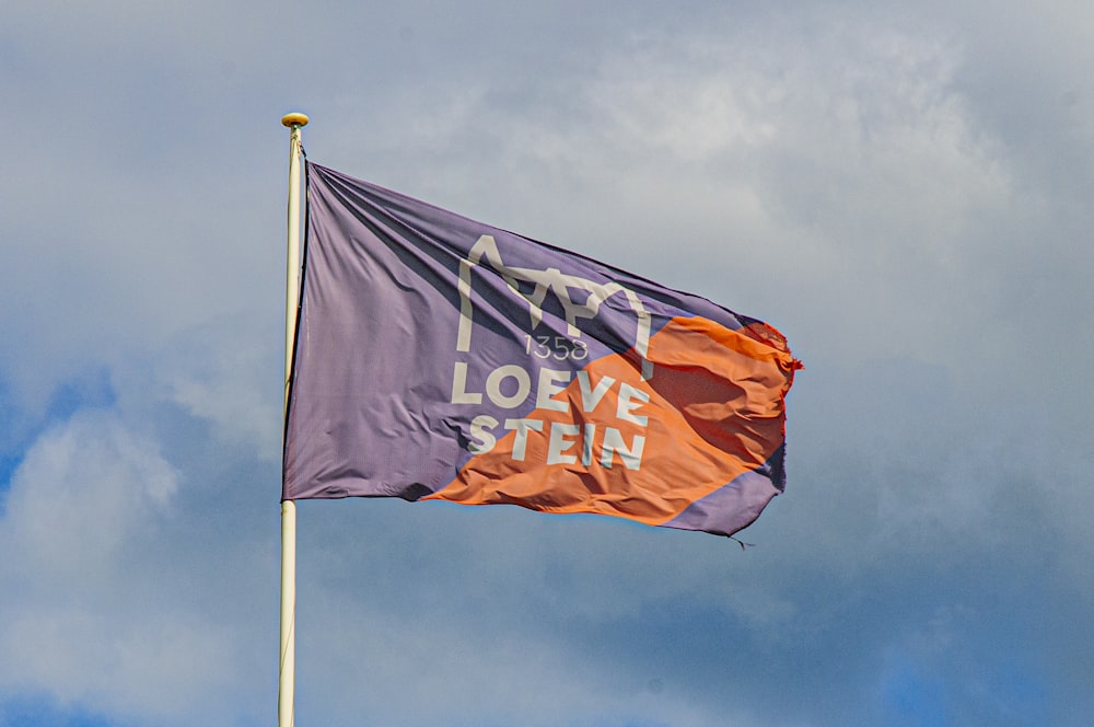 orange and white flag under blue sky during daytime