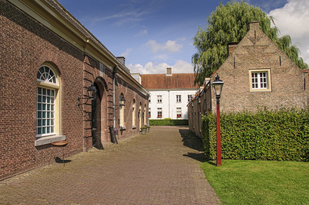 brown brick building near green grass field during daytime