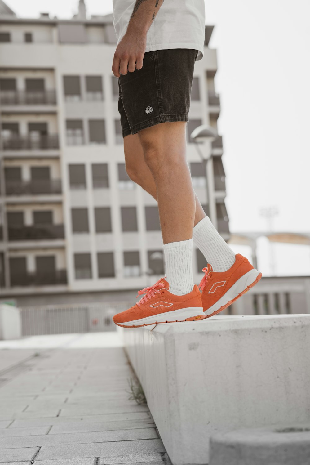 person in black shorts and red nike sneakers