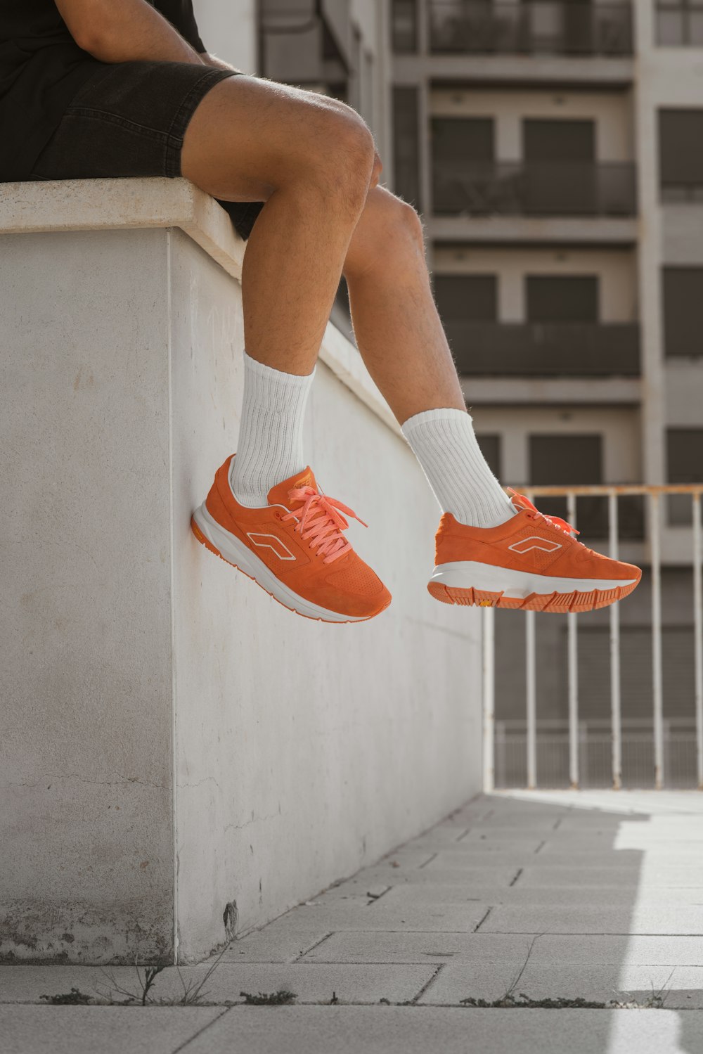 person in red and white nike sneakers