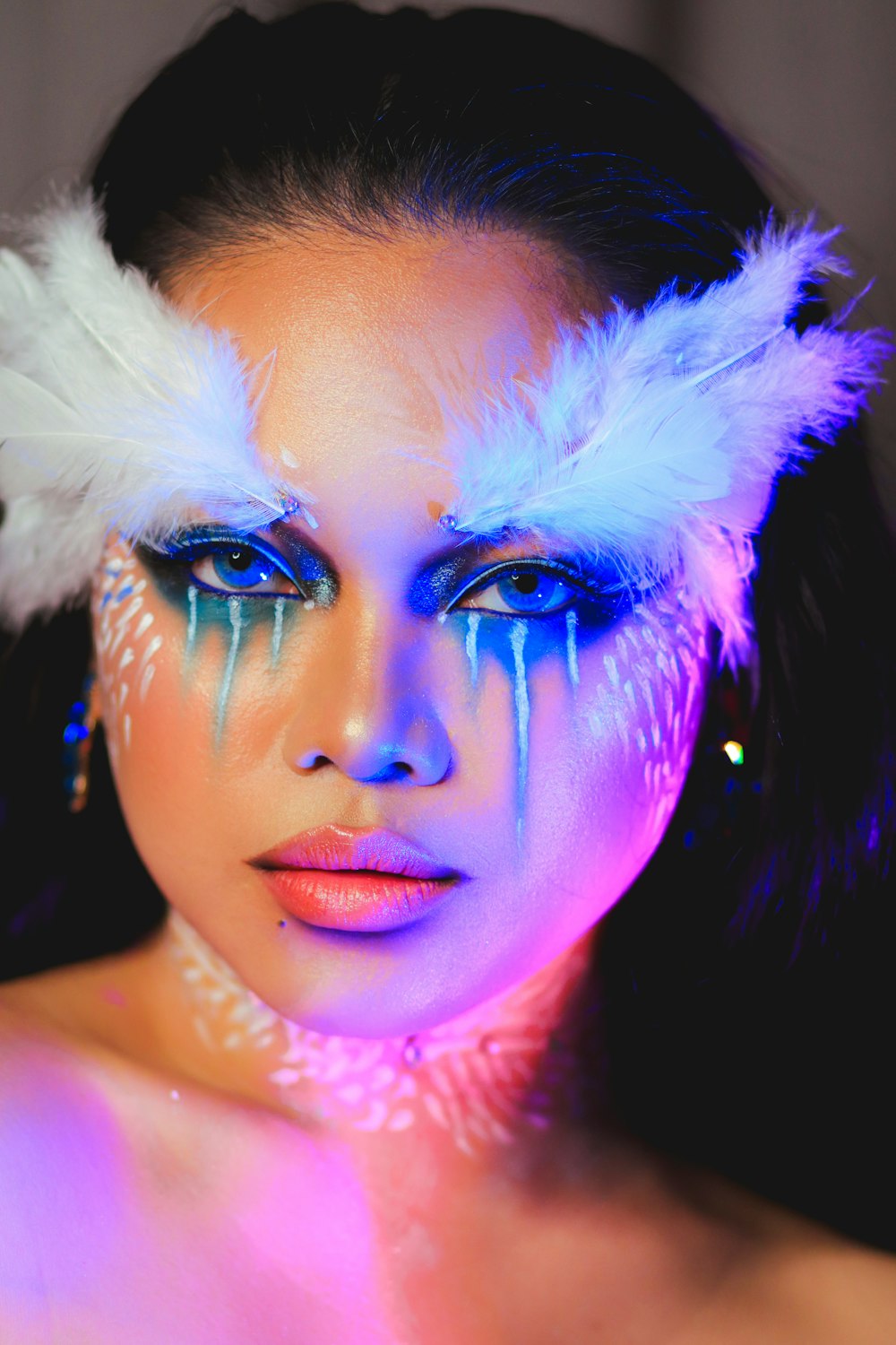 woman with white feather on her face