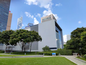 A professional lawyer reviewing urban planning documents with a modern cityscape in the background.