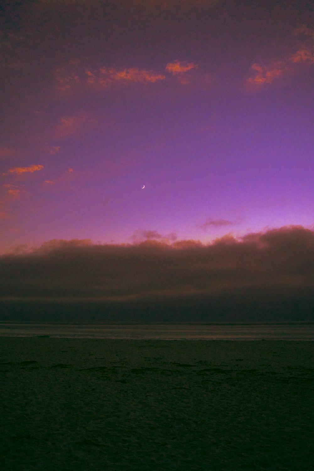 body of water under orange and blue sky