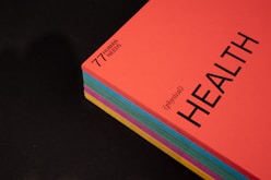 pink and black book on black surface