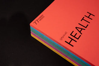 pink and black book on black surface