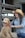 a woman in a cowboy hat petting a dog