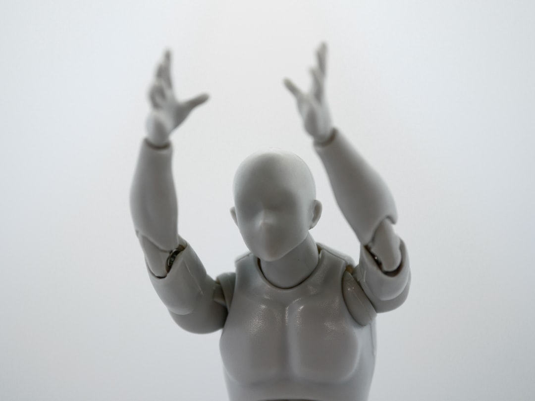 baby in white onesie lying on white surface