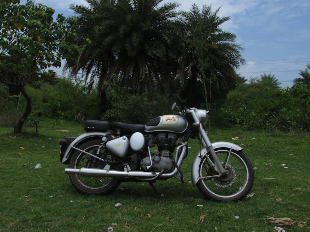 black and silver cruiser motorcycle on green grass field during daytime