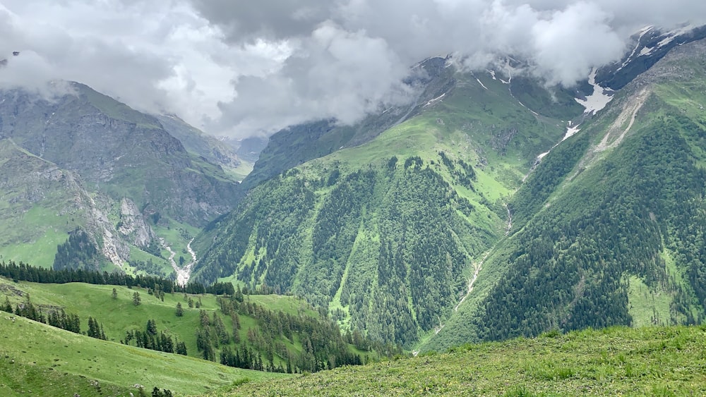 green mountains under white clouds during daytime