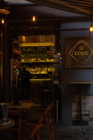 A welcoming cafe entrance with a sign that reads 'mistmatch' glowing softly in the evening.