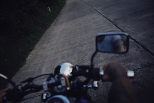 black and white motorcycle on gray concrete road