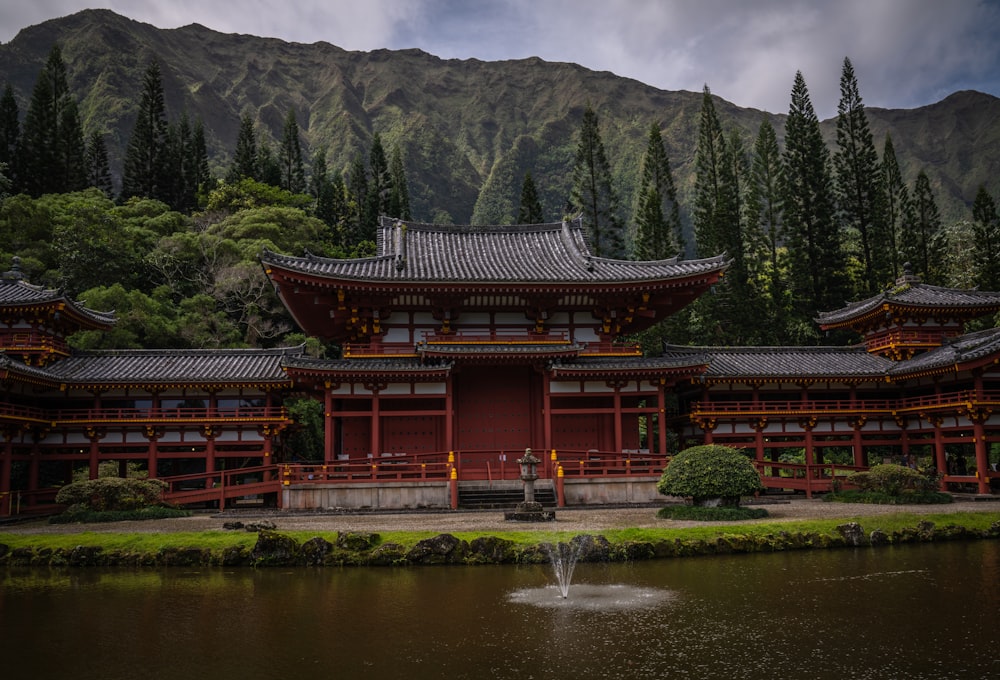 red and black temple near water fountain