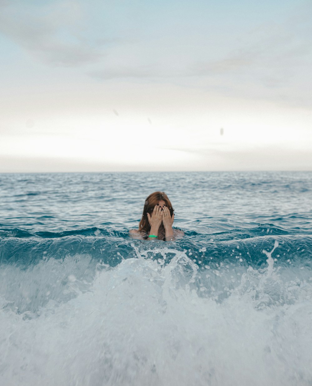woman in black bikini on blue ocean water during daytime