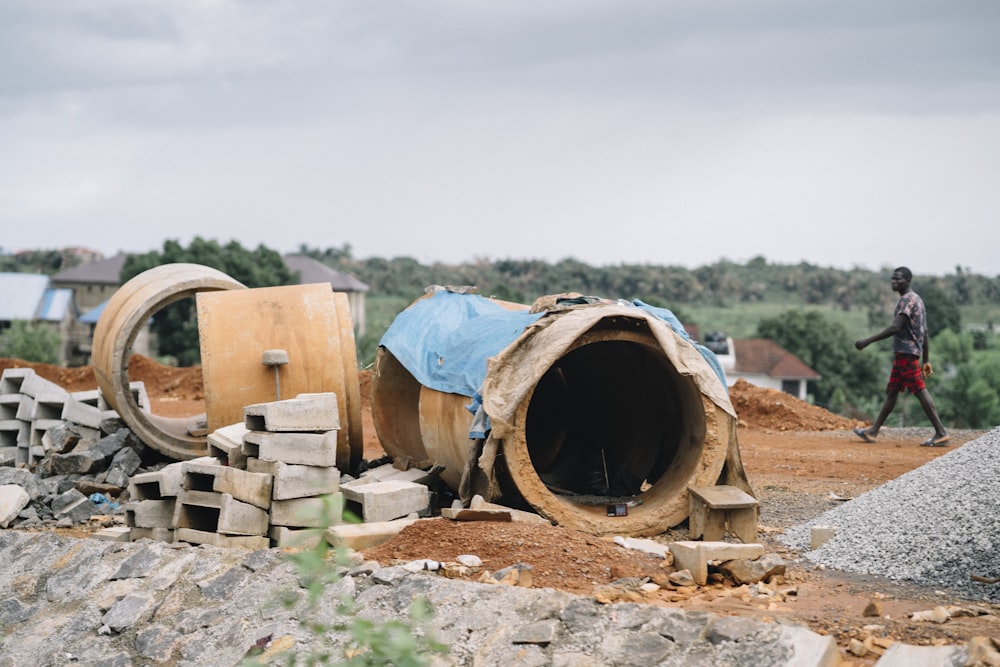 blue and brown wooden barrels on brown soil