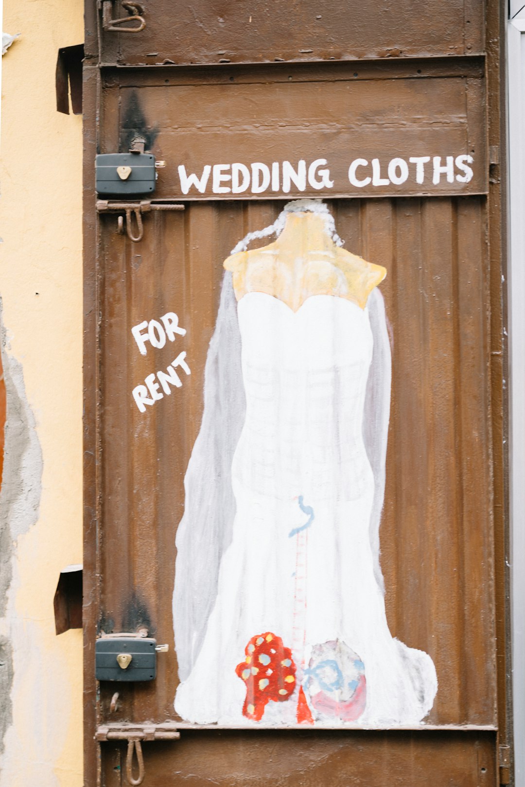 white spaghetti strap dress on brown wooden door