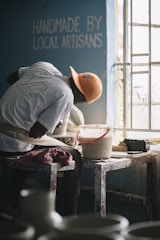 man in gray t-shirt and orange cap sitting on chair