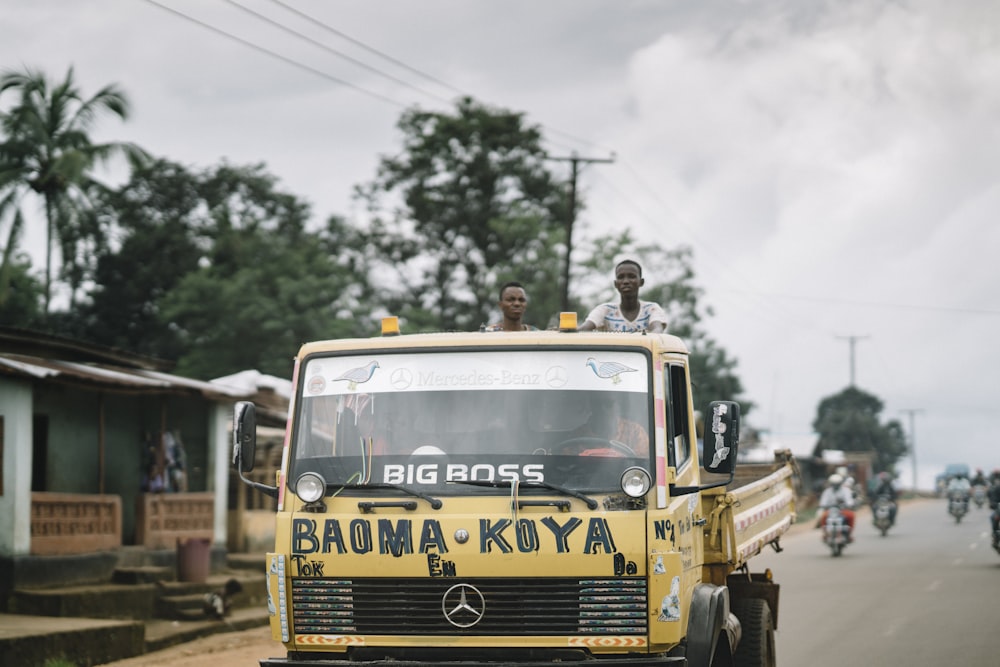 yellow truck on road during daytime