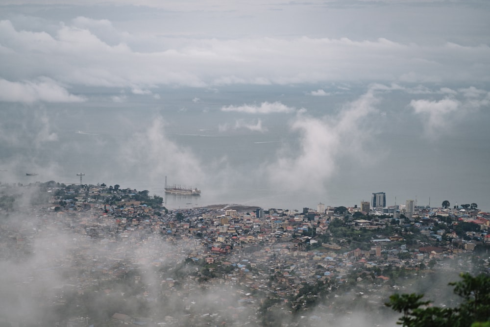 city with high rise buildings under white clouds during daytime