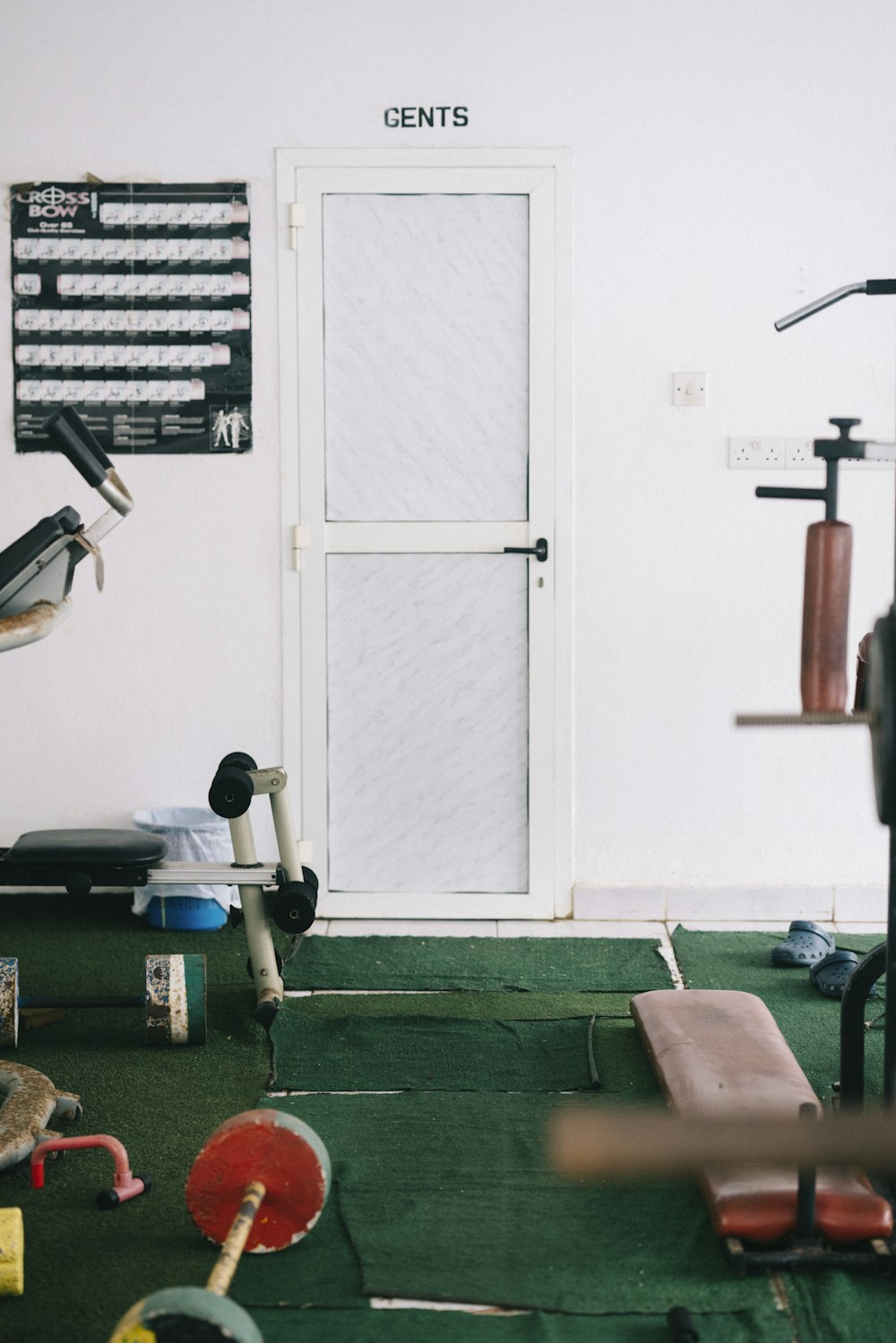 black and gray exercise equipment on green carpet