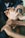 A group of hands interlocked, symbolizing unity and teamwork. The hands are of different skin tones, indicating diversity. The background is slightly blurred, emphasizing the focus on the hands in the center.