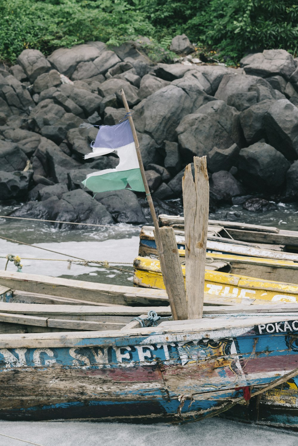 blue and yellow boat on body of water during daytime