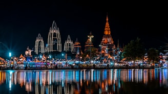 lighted building near body of water during night time