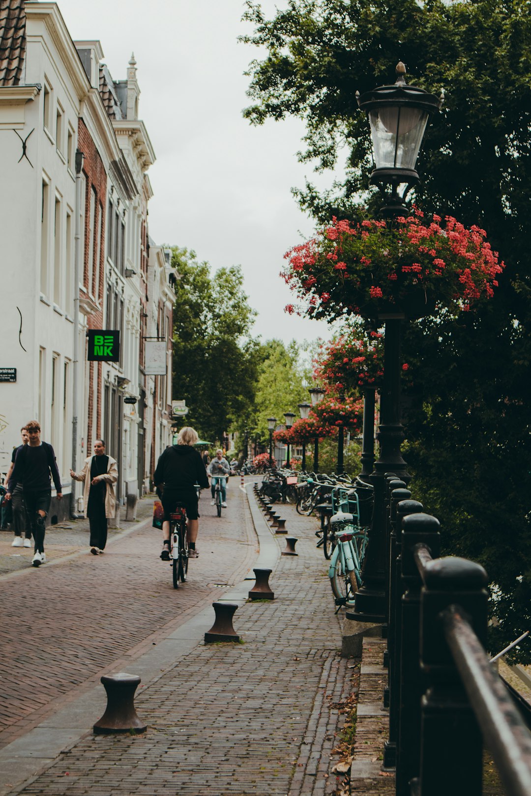 people walking on sidewalk near building during daytime