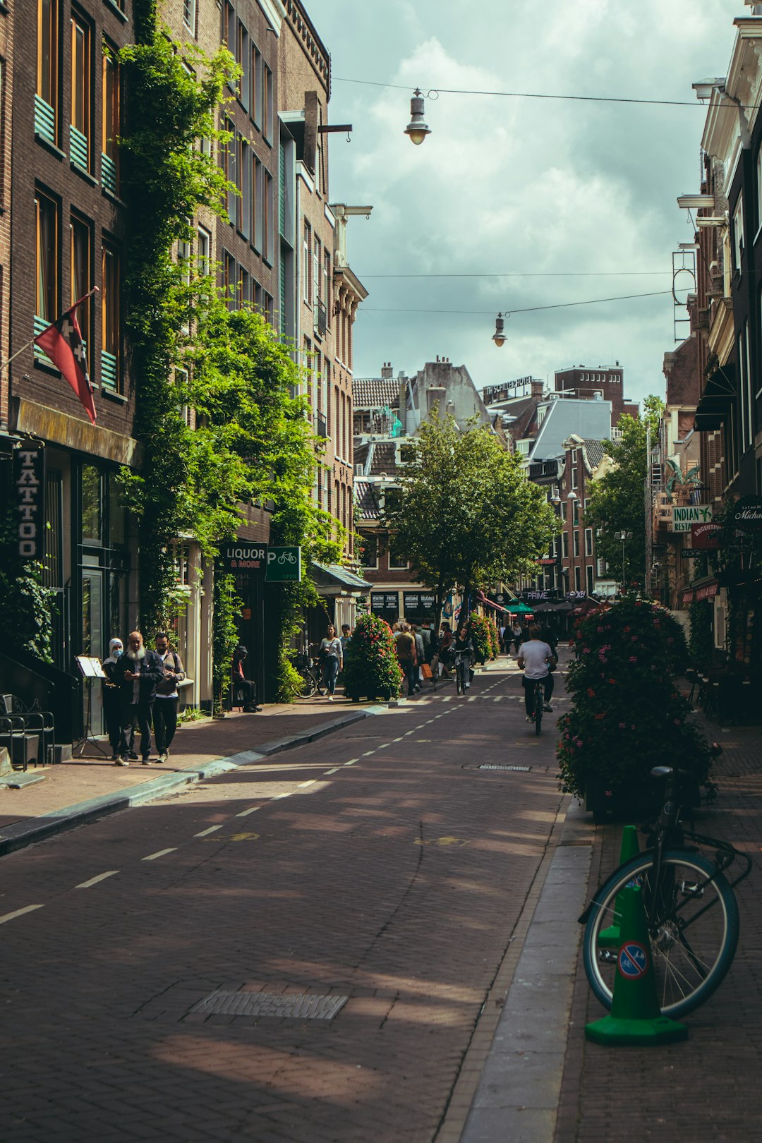 people walking on sidewalk near buildings during daytime