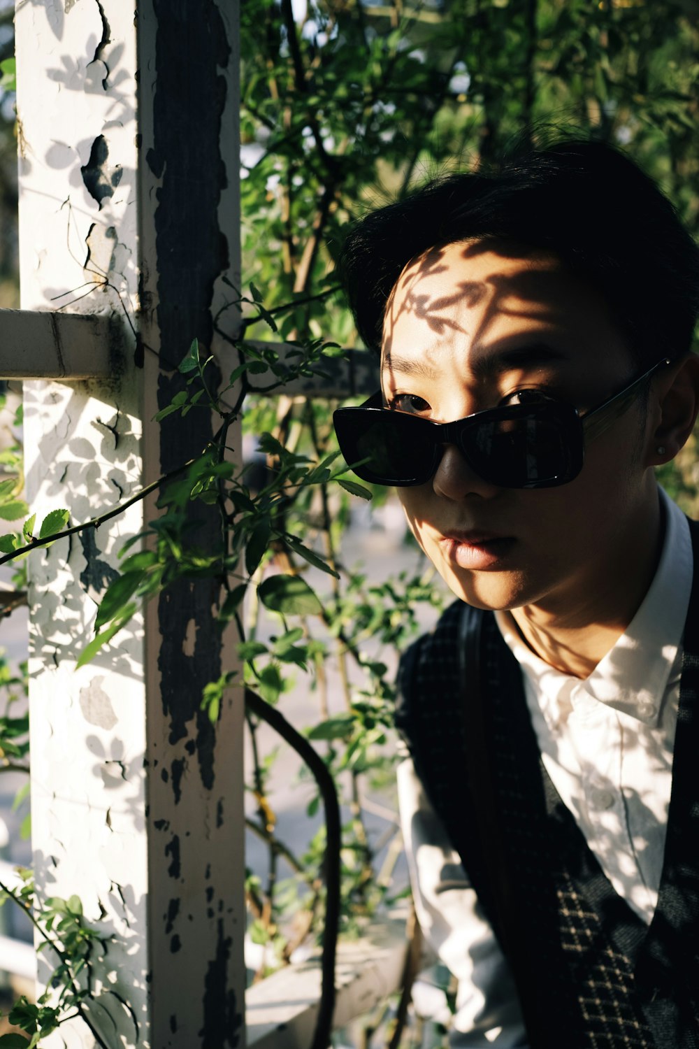 man in black and white striped blazer wearing black sunglasses