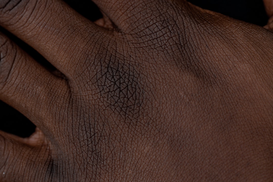 persons hand on black textile