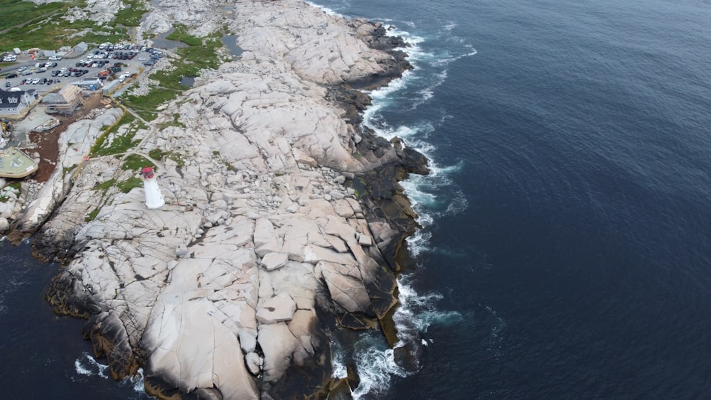 gray rock formation beside body of water during daytime