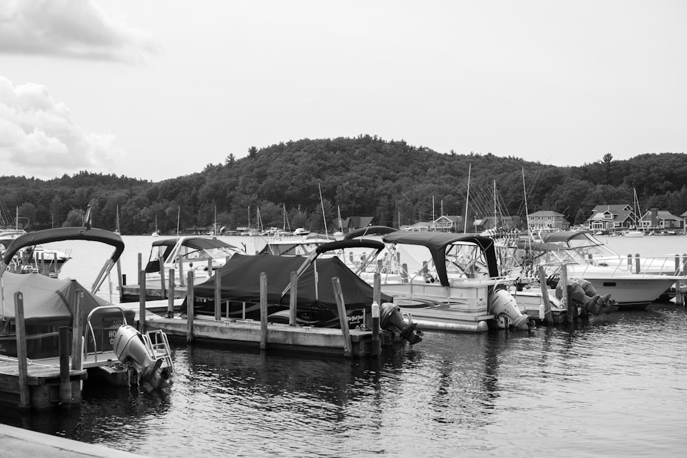 grayscale photo of boats on water