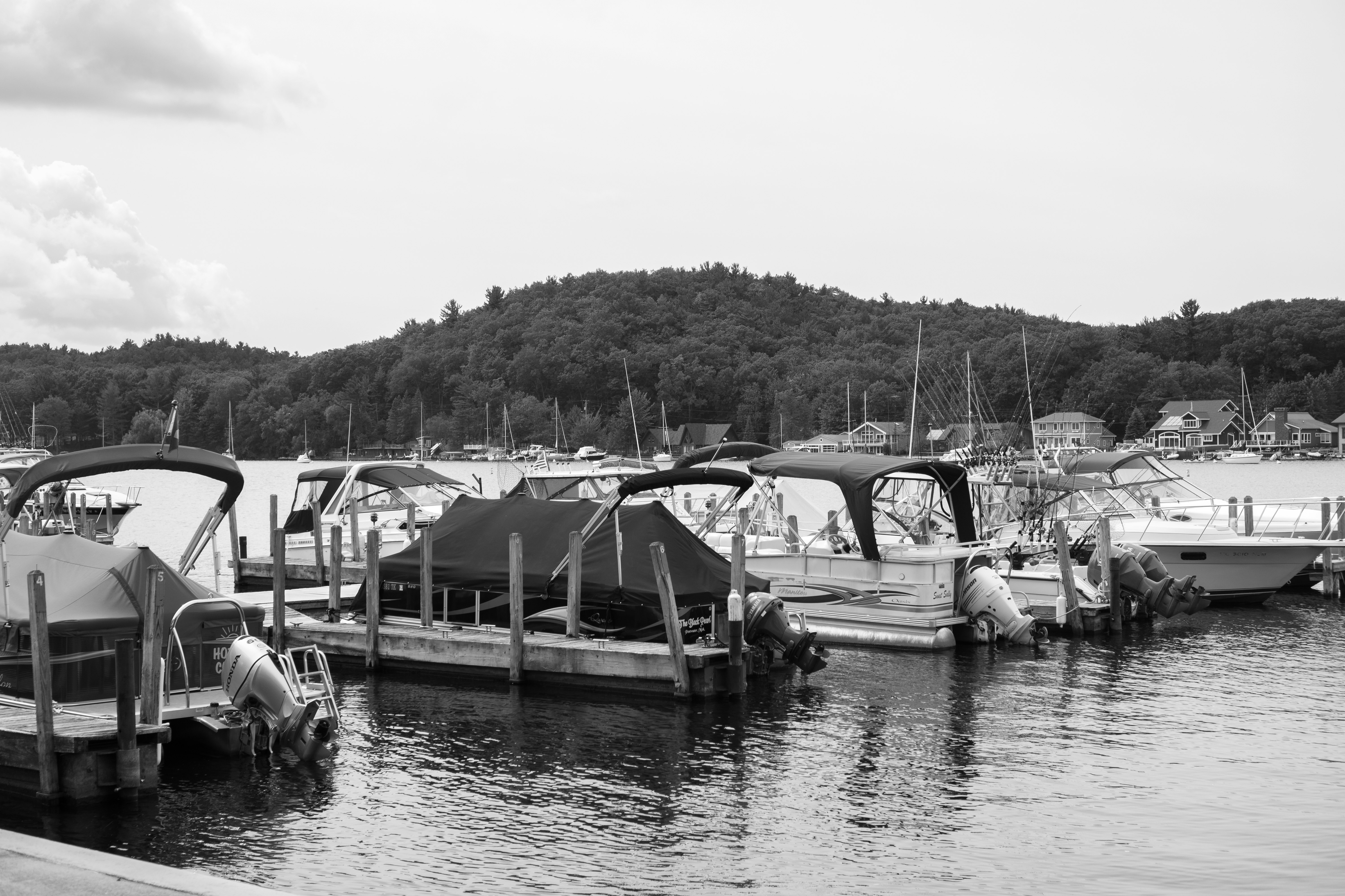 grayscale photo of boats on water