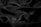Smooth, dark, glossy fabric with soft folds and a silky texture, creating gentle shadows and highlights.