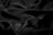 Smooth, dark, glossy fabric with soft folds and a silky texture, creating gentle shadows and highlights.