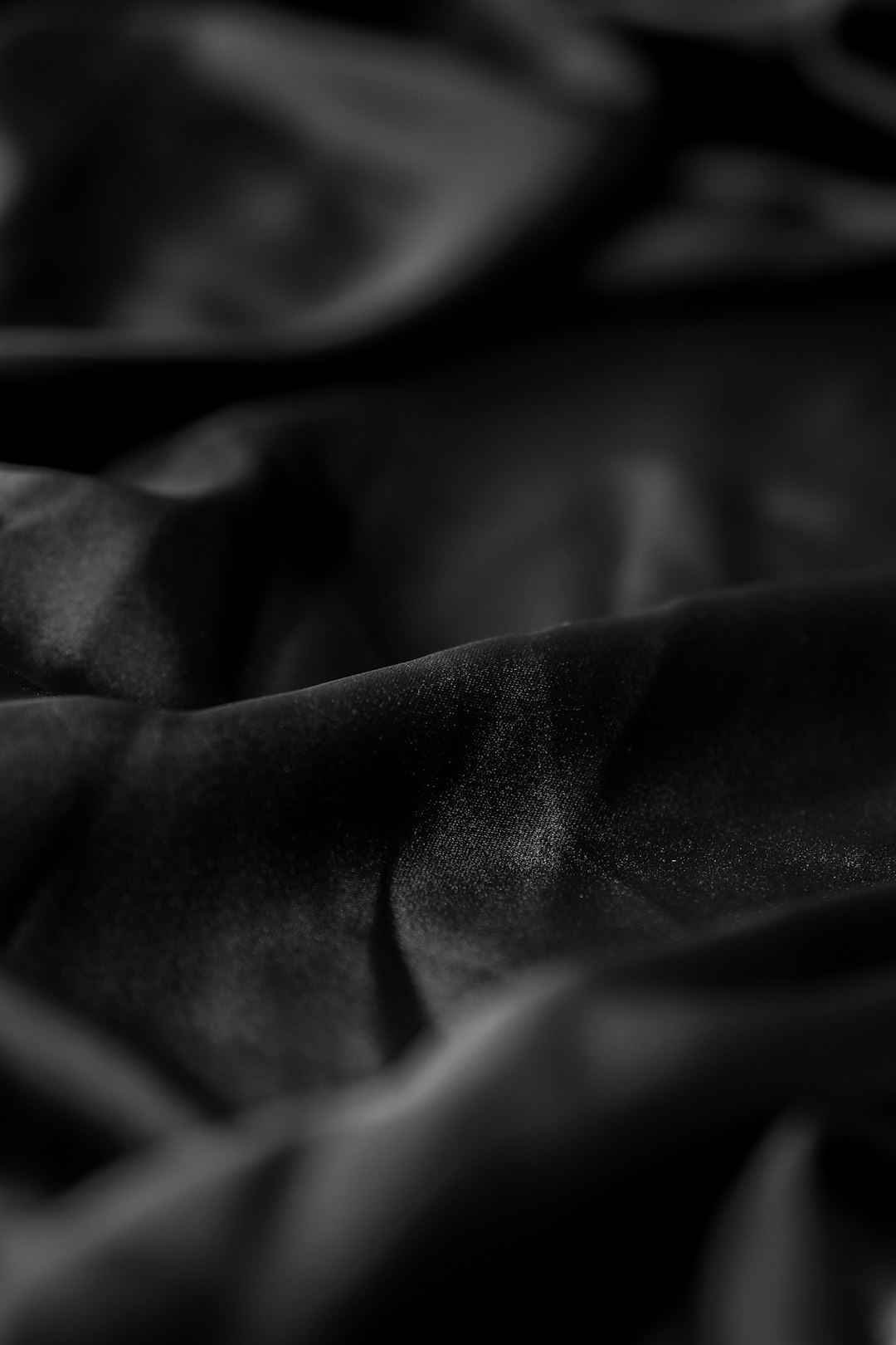 black textile in grayscale photography